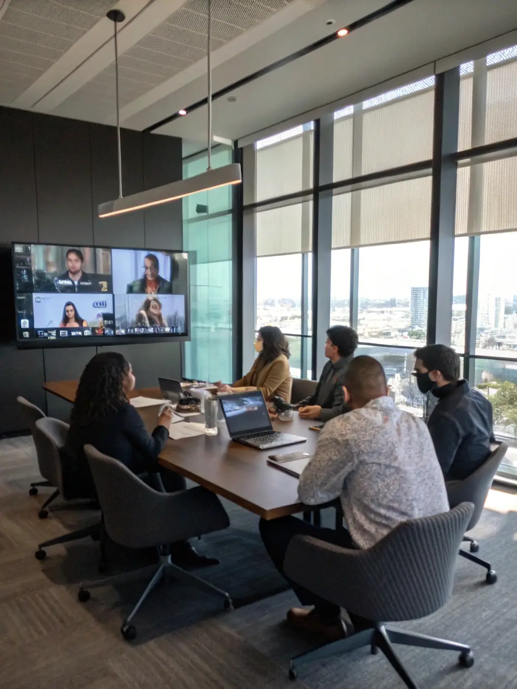 An image showing a team collaborating via video conference on multiple devices, illustrating RDVCalls' Unified Communications.